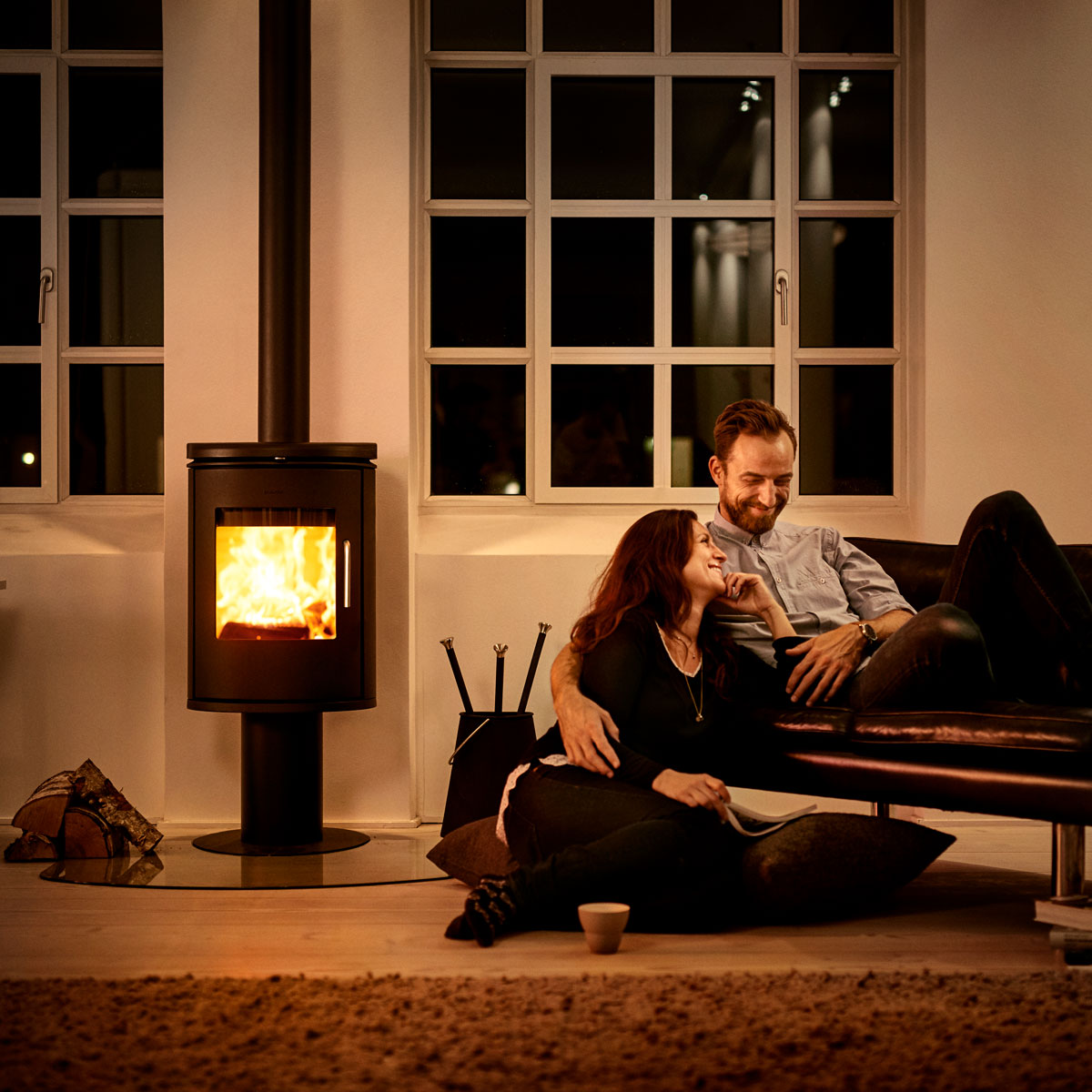 Morso 6148 wood heater in living room next to smiling couple