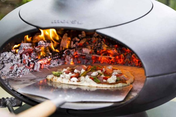 Morso Forno outdoor oven cooking pizza.