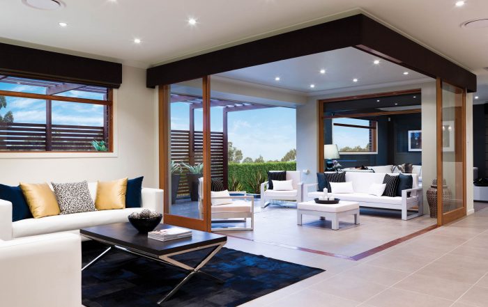 Indoor and outdoor living areas with doors open and round ducts in the ceiling