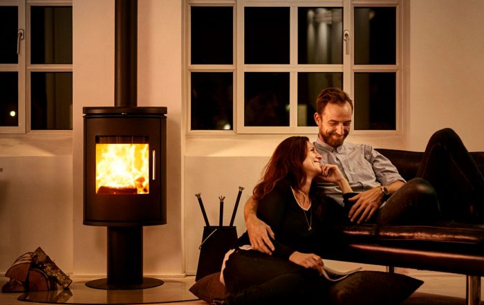 Morso 6148 wood heater in living room next to smiling couple