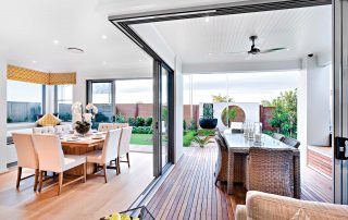Indoor and outdoor dining areas with sliding doors open