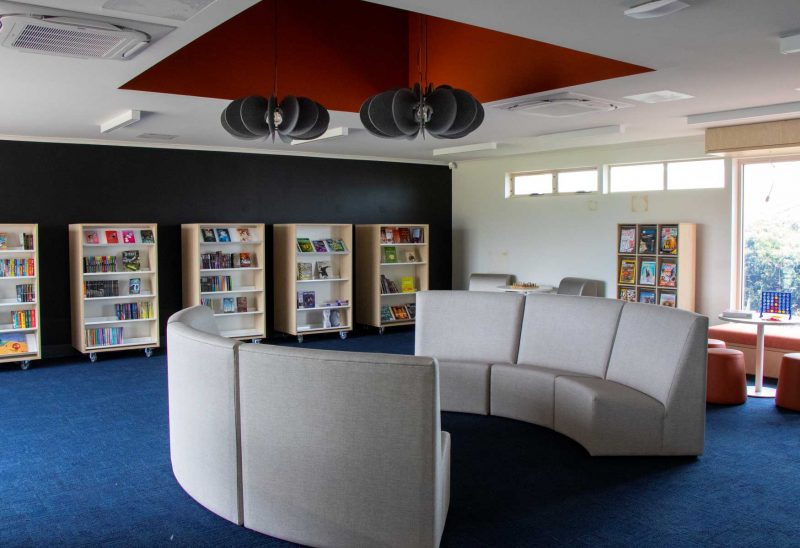 Modular lounges in modern library setting with lights and air conditioning vents in the ceiling