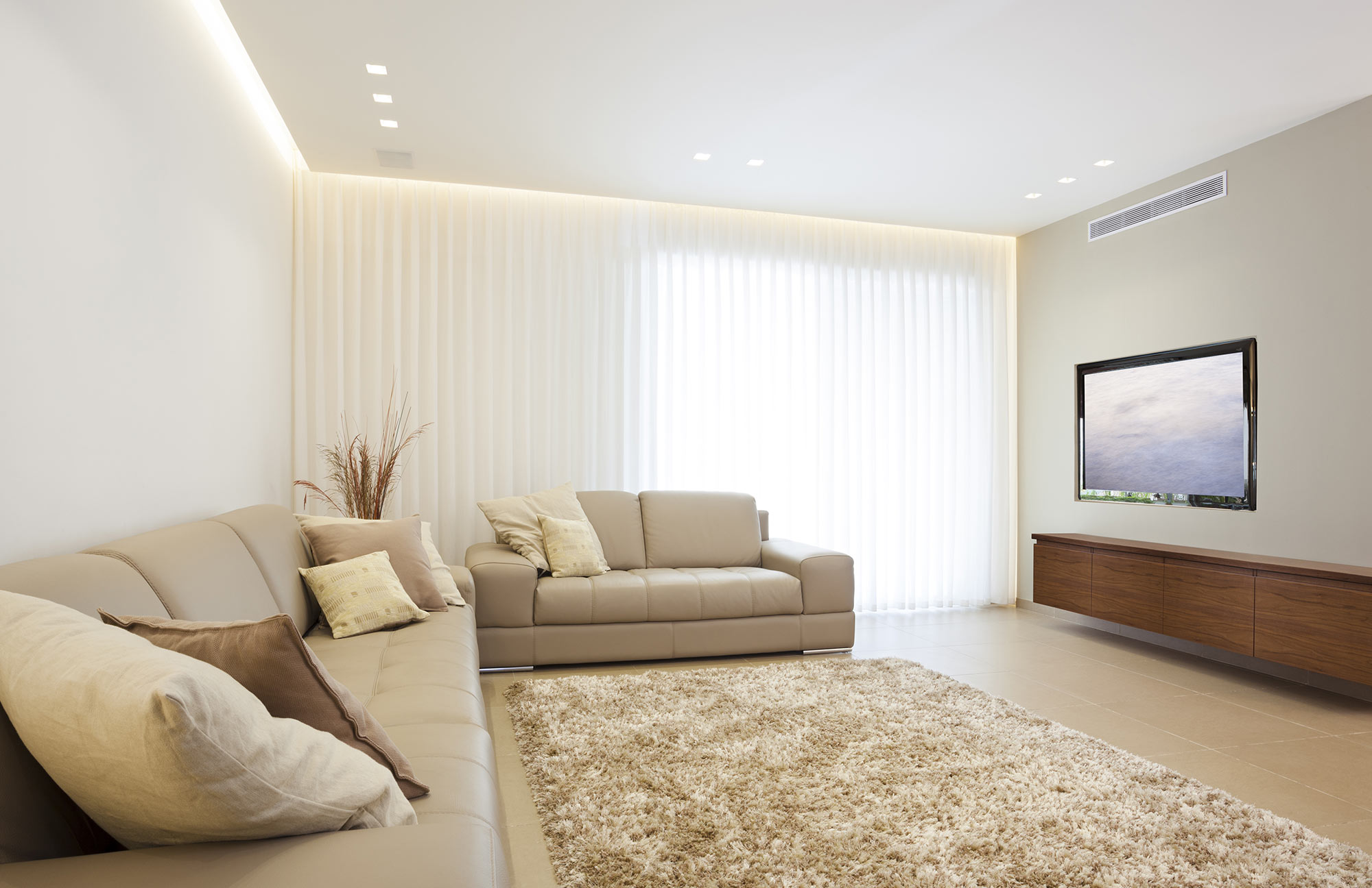 Stylish lounge room interior with ducted reverse cycle air conditioning offered by glow in adelaide